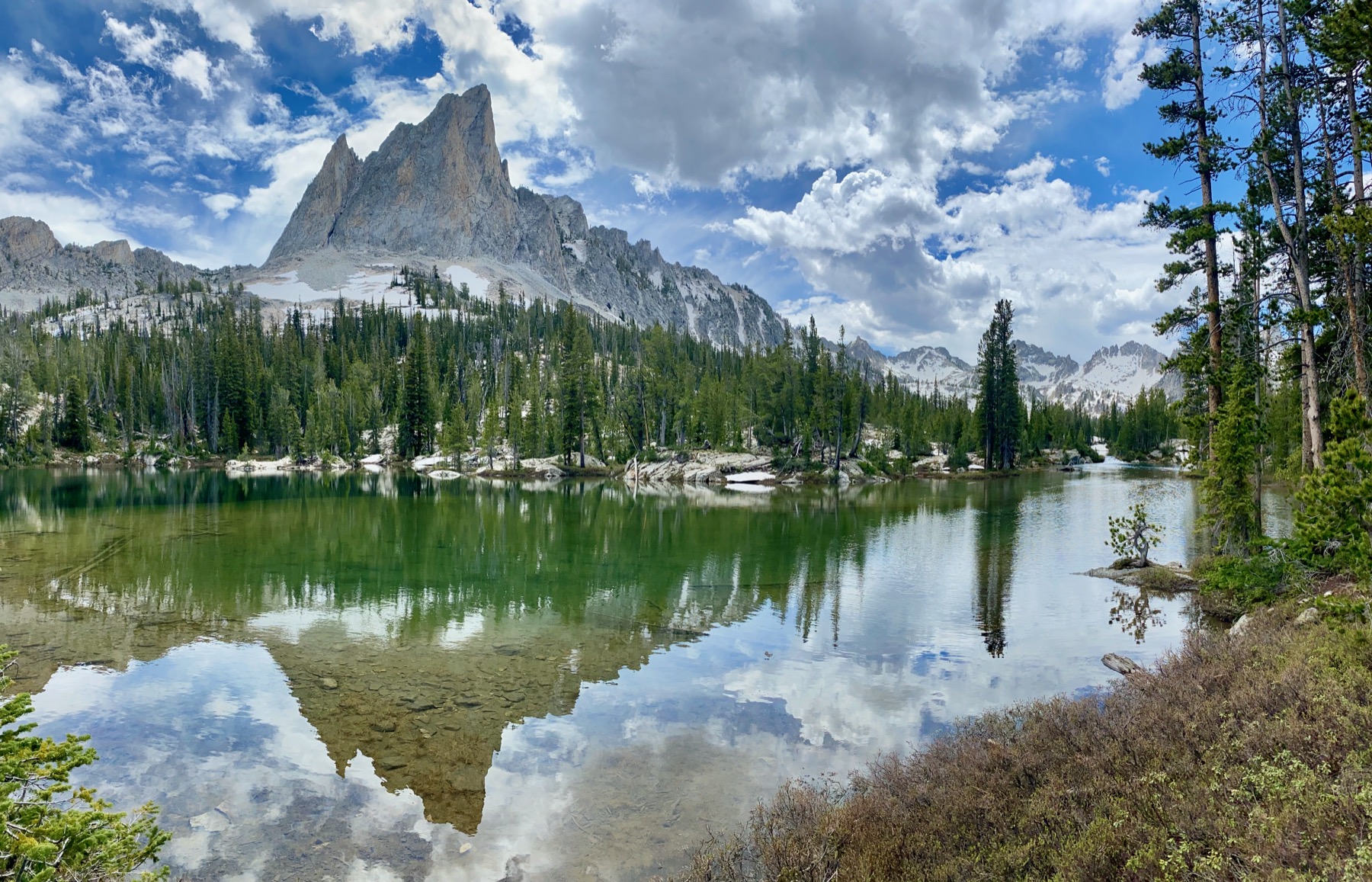 Alpine lake reflecting a granite peak in the backcountry