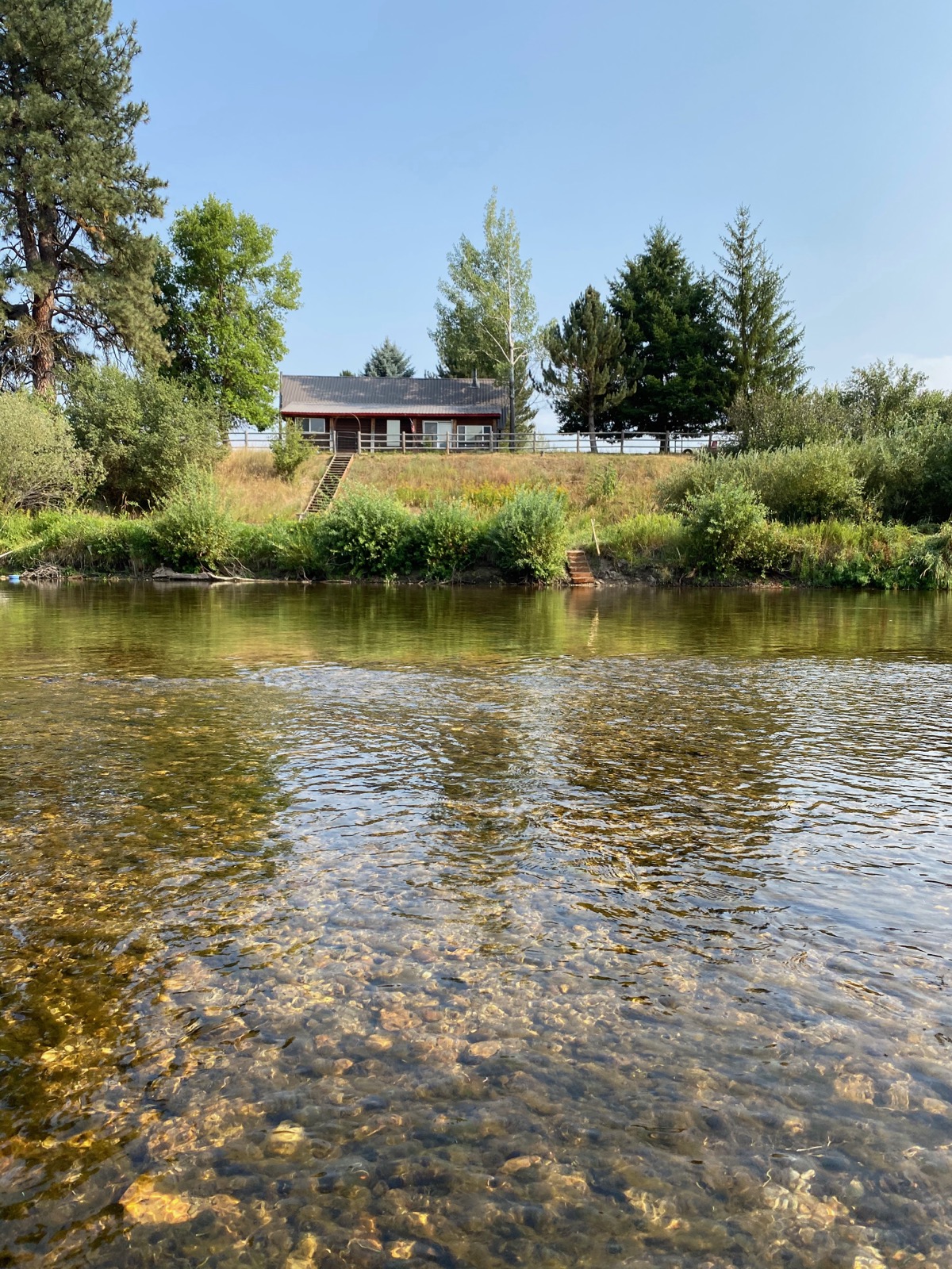 View across the Middle Fork of the Payette River toward a home on the property